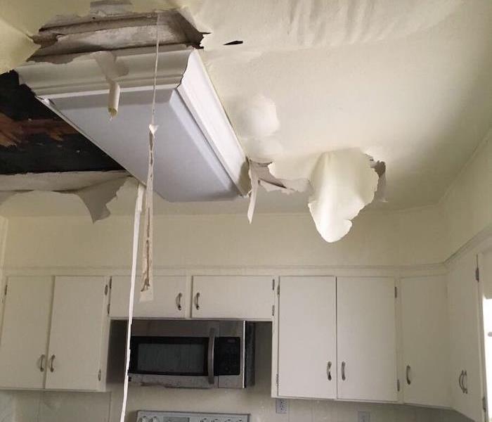 Kitchen ceiling with sagging ceiling and water damage
