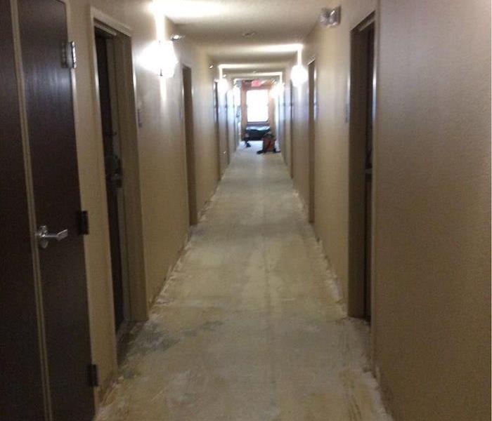 A long hallway with water removal equipment in the background