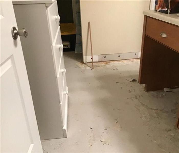 dried floor, no carpet, removed baseboards, holes at the bottom of the wall