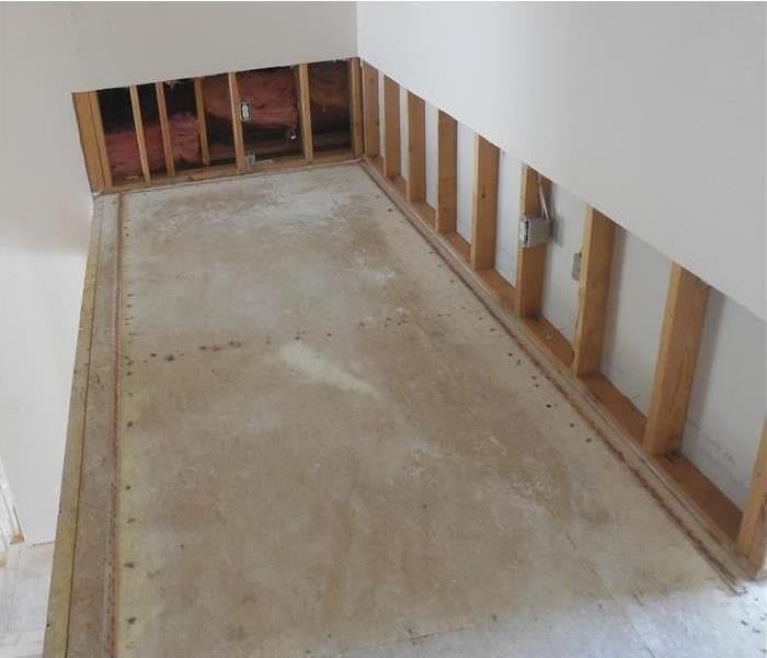 wall removed neatly at the 4-foot mark, no carpet on concrete floor