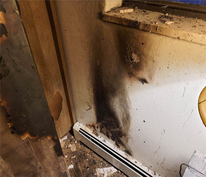 a fire damaged room with soot on the wall