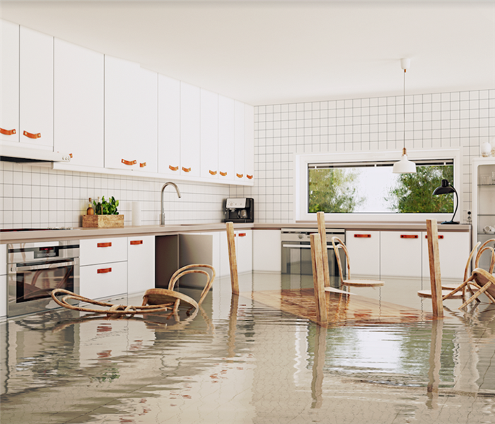 a flooded kitchen with chairs floating around