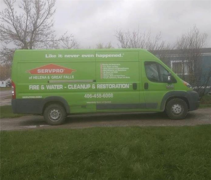 a SERVPRO van in the driveway of a home