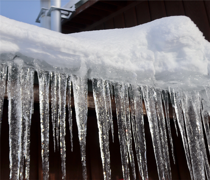 icicles forming on the edge of a roof