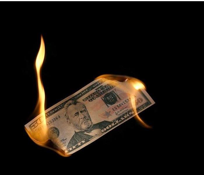 $50 bill burning from both ends
