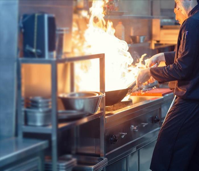 flaming skillet in a commercial kitchen